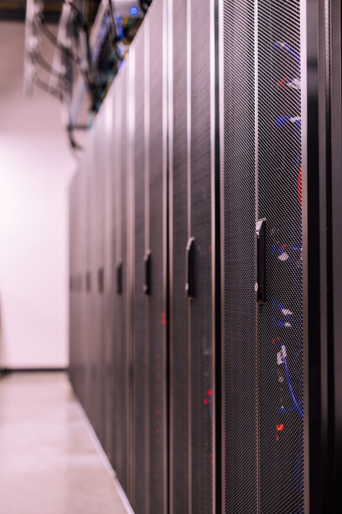 services-03 Row of similar lockers with various optic fiber cables in modern data server room